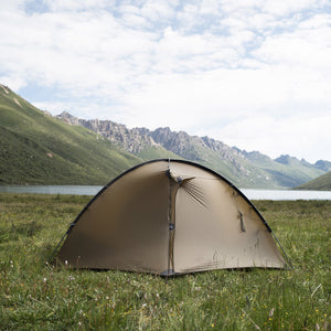 Brown TFS Stars 2 Pro with closed vestibules on grass beside a mountain lake.