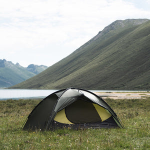 Pine green TFS Stars 2 Pro beside a mountain lake, with the vestibule open to reveal the inner tent.